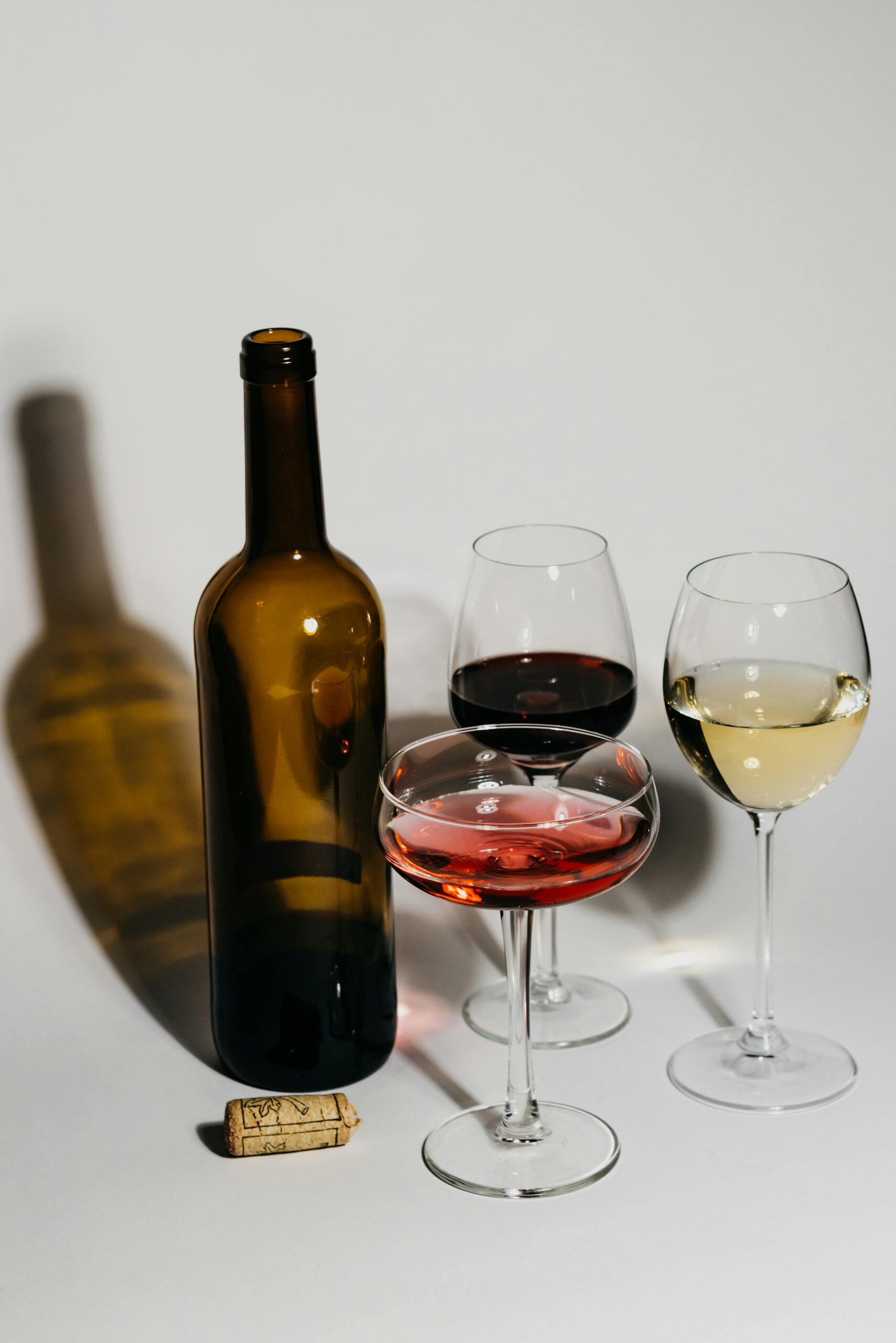 Assorted wine glasses and a bottle showcase elegance and variety.